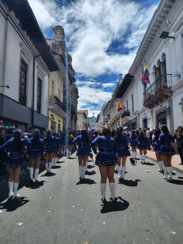 Marching band performing during the Fiestas de Quito parade through the streets of Quito.