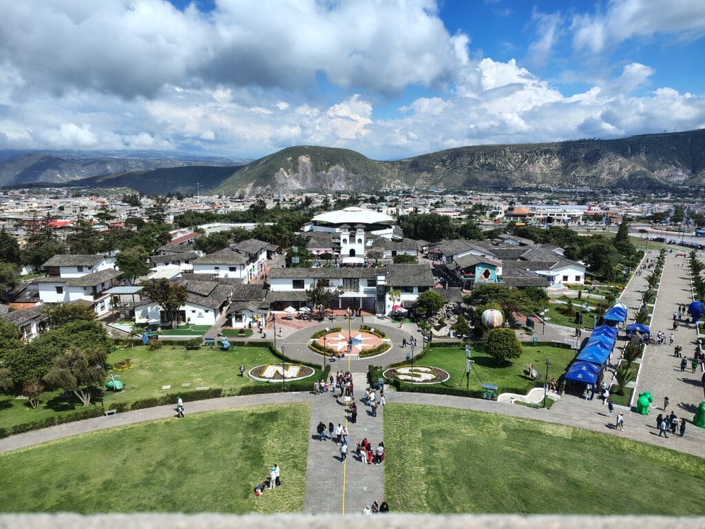 Panoramic view of Ciudad Mitad del Mundo from the observation deck of the Equator Monument near Quito, Ecuador, with the Andes Mountains in the background.