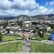 Panoramic view of Ciudad Mitad del Mundo from the observation deck of the Equator Monument near Quito, Ecuador, with the Andes Mountains in the background.