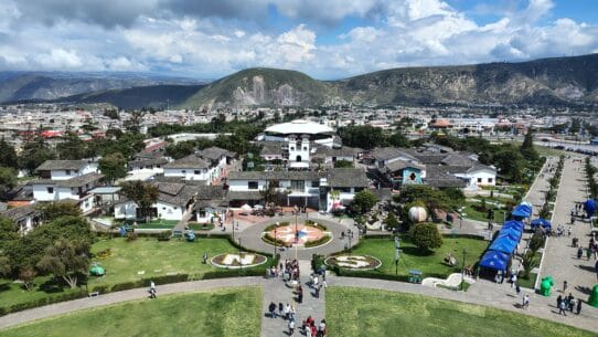 Panoramic view of Ciudad Mitad del Mundo from the observation deck of the Equator Monument near Quito, Ecuador, with the Andes Mountains in the background.
