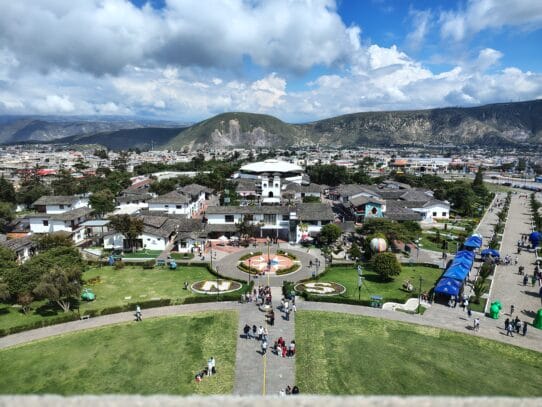 Panoramic view of Ciudad Mitad del Mundo from the observation deck of the Equator Monument near Quito, Ecuador, with the Andes Mountains in the background.