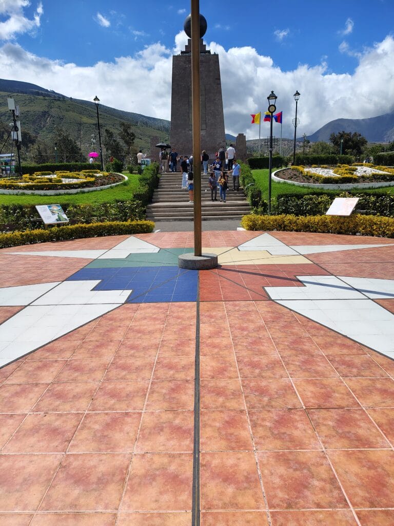 Visitors walking through the central plaza of Ciudad Mitad del Mundo in Ecuador.