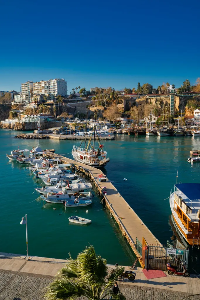 Boats moored in Antalya's old harbor beside the city on Türkiye's Mediterranean coast