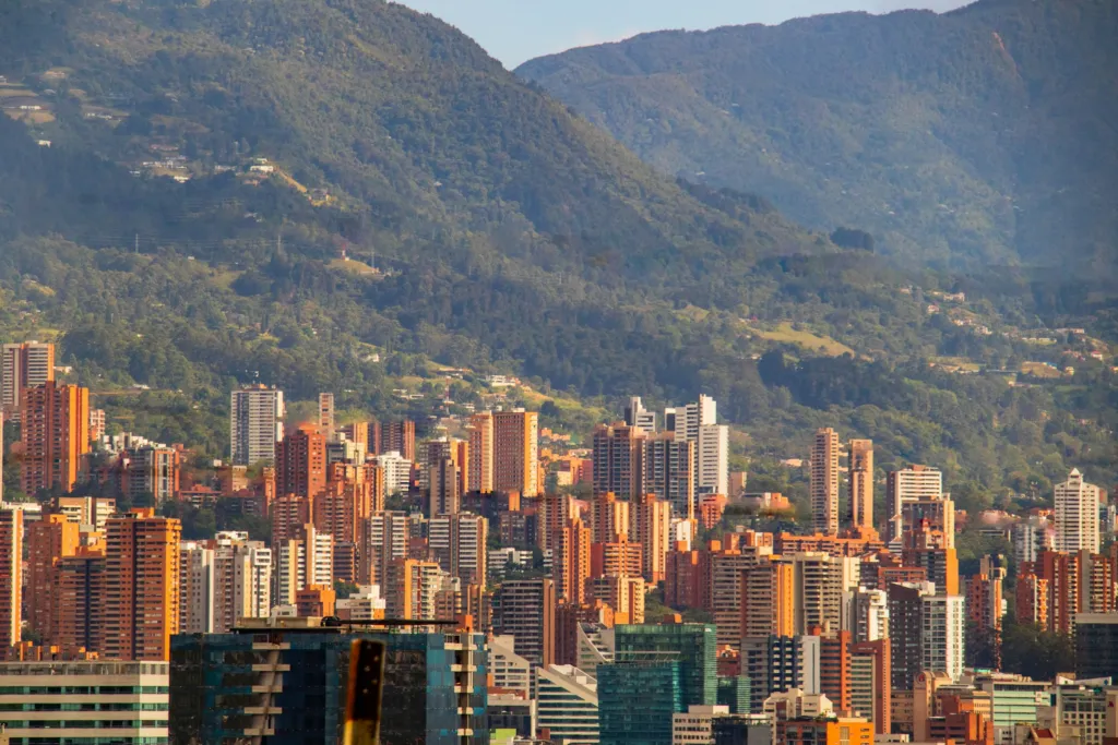Medellín's high-rises with the green mountains of the Aburrá Valley behind them in Colombia