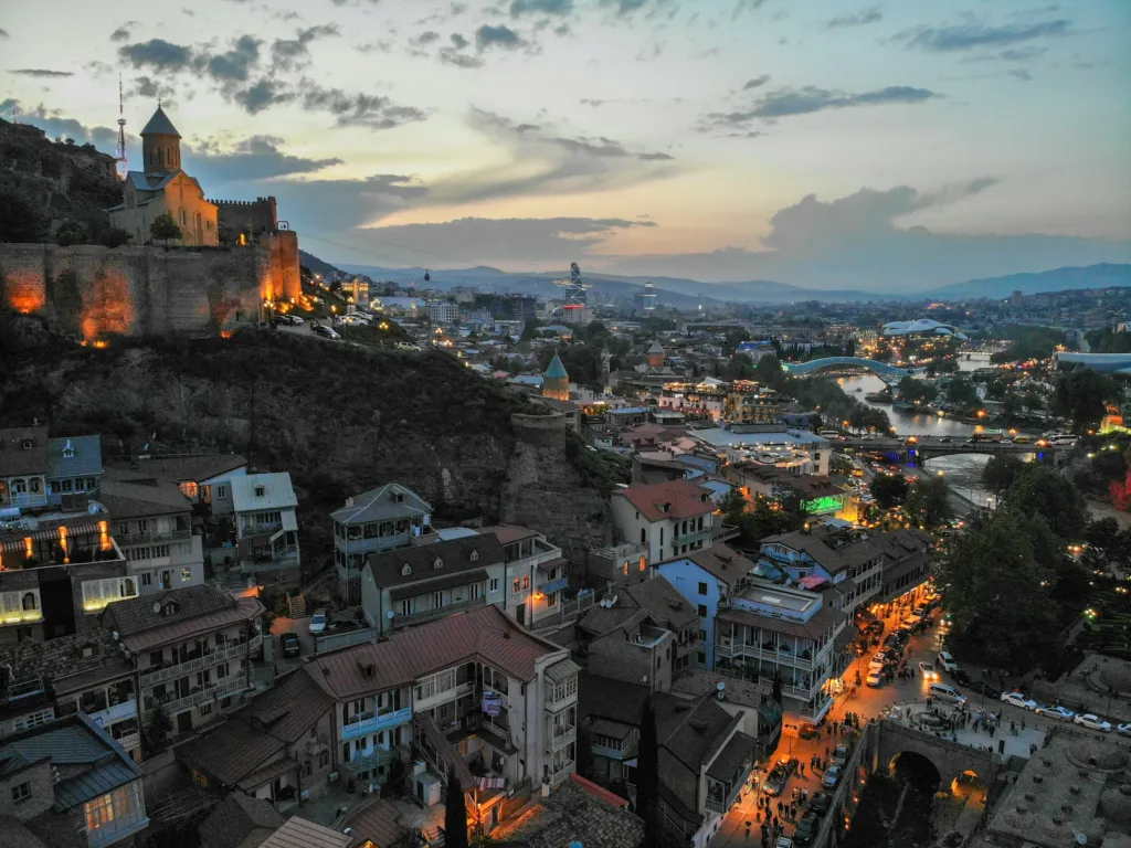 Aerial view of the houses and streets of Tbilisi's old city at sunset in Georgia