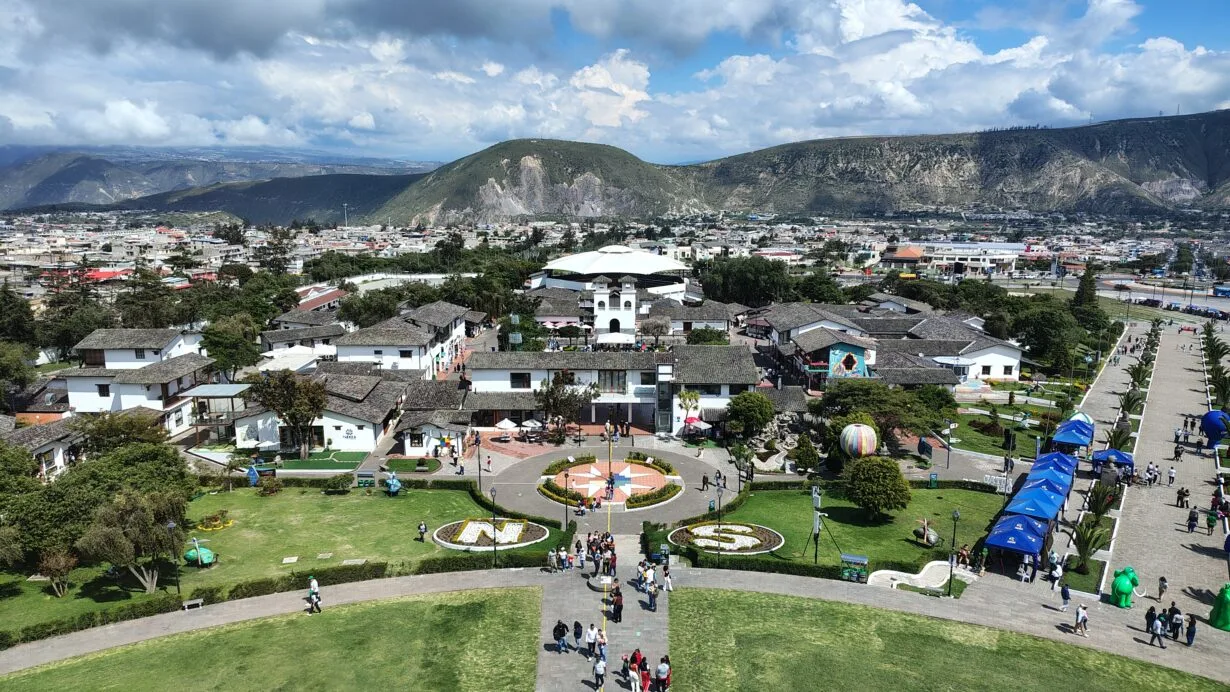 Panoramic view of Ciudad Mitad del Mundo from the observation deck of the Equator Monument near Quito, Ecuador, with the Andes Mountains in the background.
