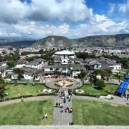 Panoramic view of Ciudad Mitad del Mundo from the observation deck of the Equator Monument near Quito, Ecuador, with the Andes Mountains in the background.
