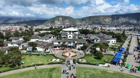 Panoramic view of Ciudad Mitad del Mundo from the observation deck of the Equator Monument near Quito, Ecuador, with the Andes Mountains in the background.
